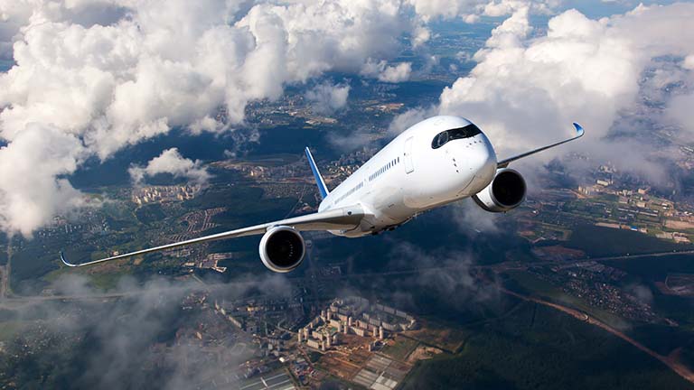 Aeroplane flying upwards through clouds