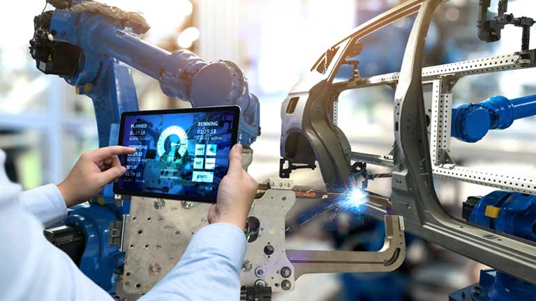 Person controlling robotic machinery with a tablet