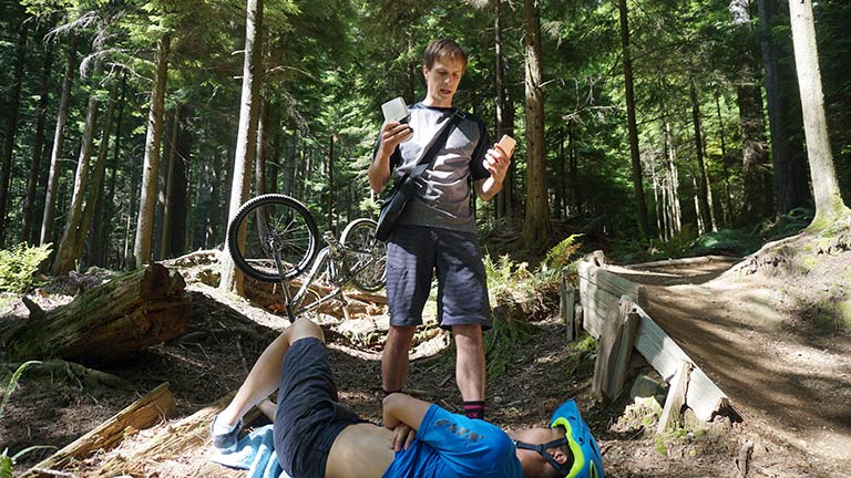 Injured man being cared for in forest