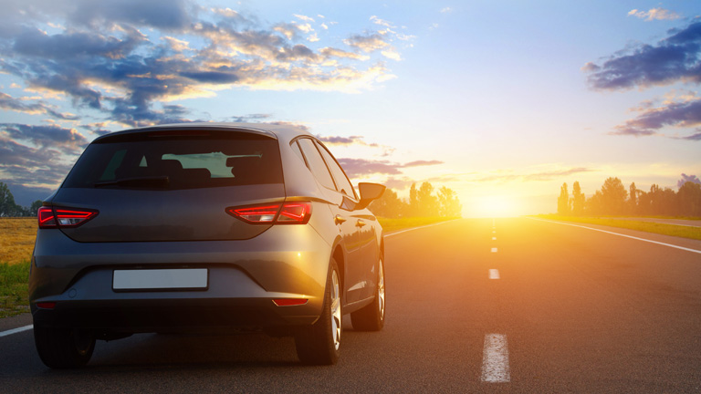 smart car on the road at sunset