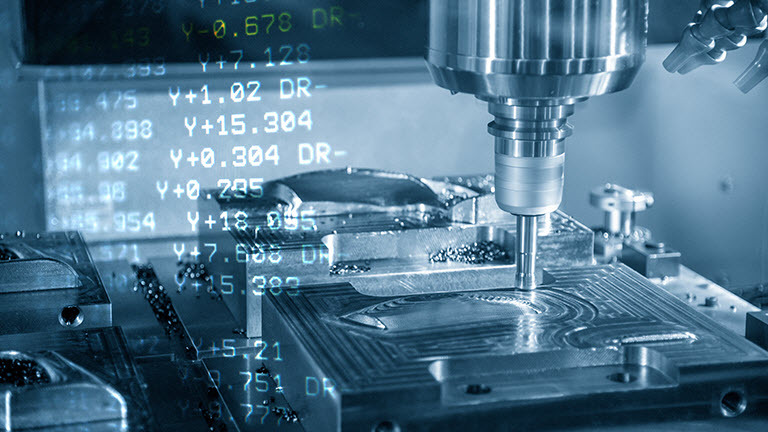 A cnc machine is milling a piece of metal